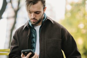 Image of male looking at his mobile